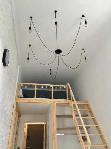 a chandelier in a room with a staircase at Apartament Żelazna in Warsaw