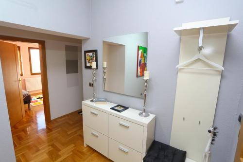 a room with a dresser with a mirror on the wall at Farah Superior Apartments in Bihać