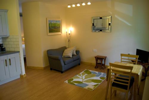 a living room with a couch and a table at Old School House Belcoo 41 in Belcoo