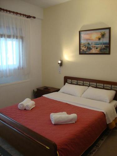 a bedroom with a large bed with two towels on it at Stalaktites in Ioannina