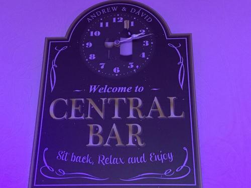 a sign for a central bar with a clock on it at The Danescourt in Blackpool