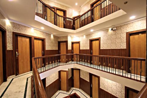 an image of a building with stairs and elevators at Hotel Empire Central Street in Bengaluru