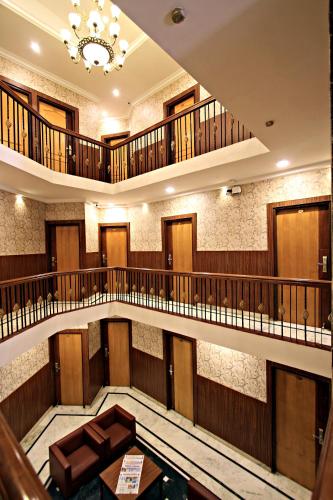 a large building with a large lobby with stairs at Hotel Empire Central Street in Bengaluru
