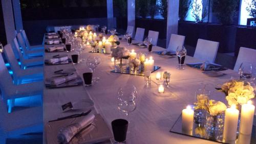 a long table with candles and flowers on it at LHP Hotel Montecatini Palace & SPA in Montecatini Terme