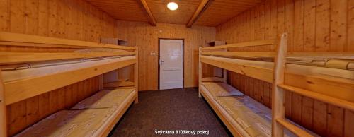 a room with four bunk beds in a cabin at Turistická chata Švýcarna in Loučná nad Desnou