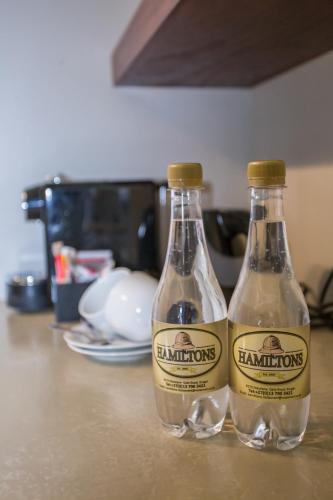two bottles of champagne sitting on top of a counter at Hamiltons Lodge & Restaurant in Malelane