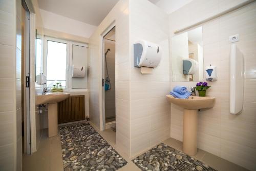 a bathroom with two sinks and a shower at Holiday Home White House in Podstrana