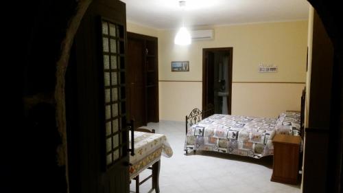 a bedroom with two beds and a door to a room at Villa Laura Apartment in Giardini Naxos