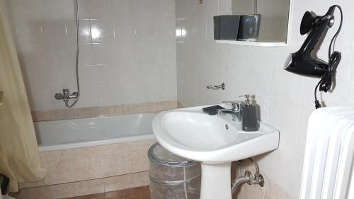 a bathroom with a sink and a bath tub at Errathens Wheat Apartment - Athens Center, 3 BD, 1 BATH in Athens
