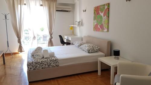 a bedroom with a bed with two stuffed animals on it at Errathens Wheat Apartment - Athens Center, 3 BD, 1 BATH in Athens
