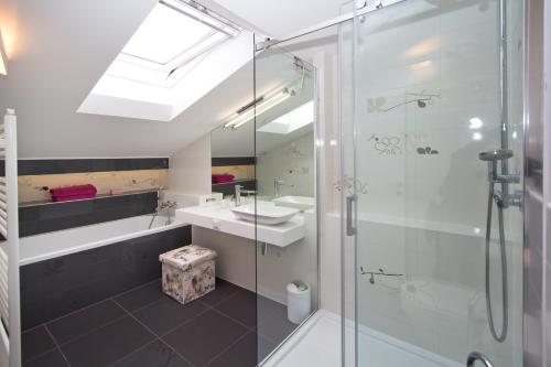a bathroom with a glass shower and a sink at Apartments Adria in Poreč