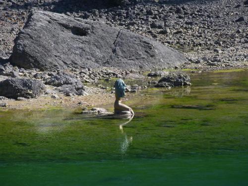 a man standing in a body of water at Apartments Haus Martin in Nova Levante
