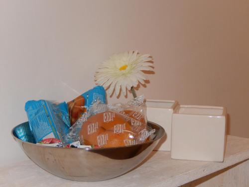 a bowl of candy on a counter with a flower at Sant'Alfonso Maria De Liguori Rooms in Nola