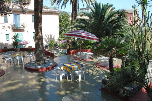 a patio area with umbrellas, tables, chairs and umbrellas at Hotel 5 Terre in Monterosso al Mare