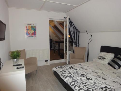 um quarto com uma cama e uma mesa com cadeiras em Riethove em Harlingen