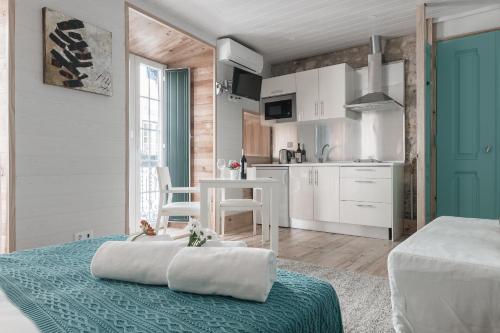 a kitchen and living room with a bed and a table at My Bairro Alto Suites in Lisbon