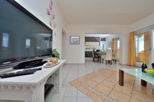 a living room with a large flat screen tv at Villa Dalmatina Zadar mit Pool in Zadar