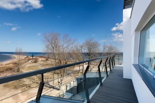 a balcony with a view of the beach at Hotel Skipper in Rewa