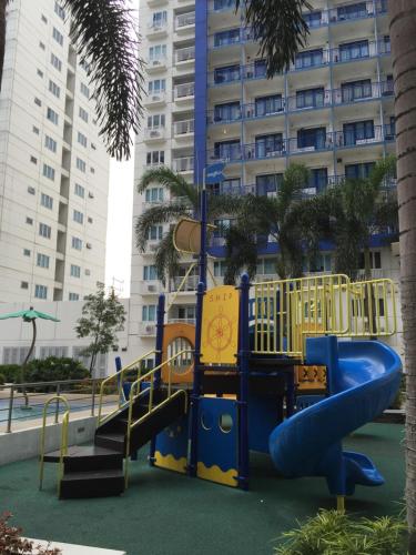 a playground in front of a tall building at Sea Residences MoA Manila in Manila