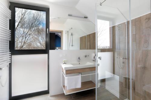 a bathroom with a sink and a shower at Hotel Skipper in Rewa