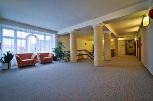 a lobby with couches and chairs in a building at Atlantic Hotel in Prague