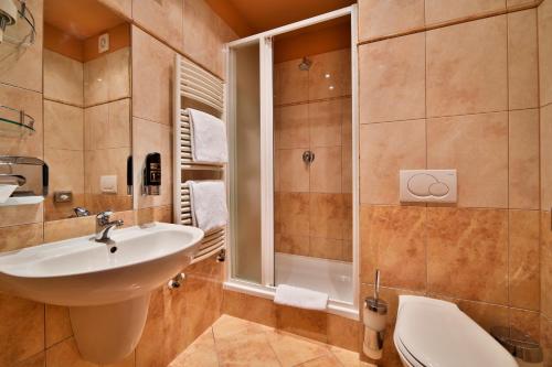 a bathroom with a sink and a shower at Atlantic Hotel in Prague