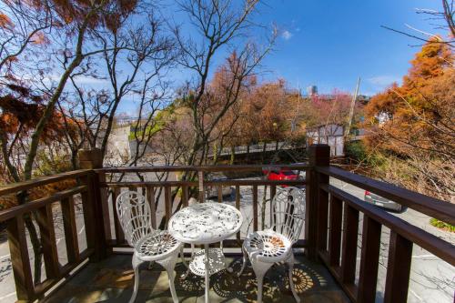 a balcony with two chairs and a table at The Cotswolds Villa in Renai