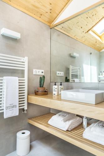 a bathroom with a sink and a mirror at Cestaria Costa Nova in Costa Nova