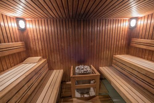 a sauna with two benches and a table in it at Hotel Kalma, Kalma Villa, Apart Hotel in Hévíz