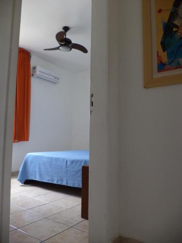 a bedroom with a ceiling fan and a bed at Apartamento Boa Viagem in Recife