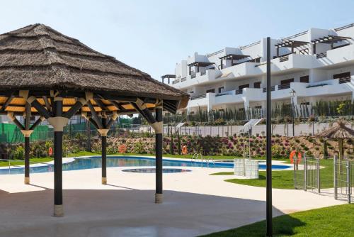 a resort with a swimming pool and a large building at Mar de Pulpí Las Azucenas by Mar Holidays in San Juan de los Terreros