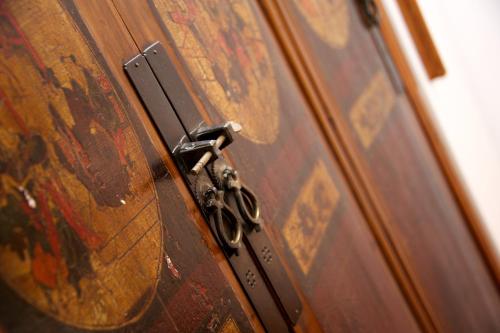 a metal door with a pair of scissors on it at Villa Lieta in Ischia