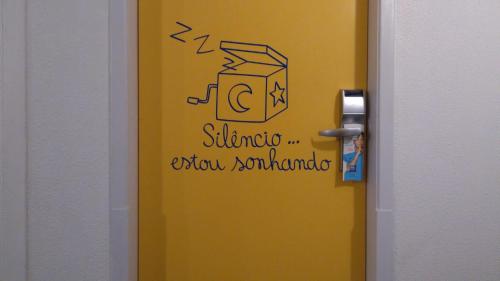a door with a drawing of a toaster on it at ibis budget Curitiba Centro in Curitiba