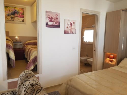 a bedroom with two beds and a mirror at Pietra di Luna relaxing private terrace in Polignano a Mare