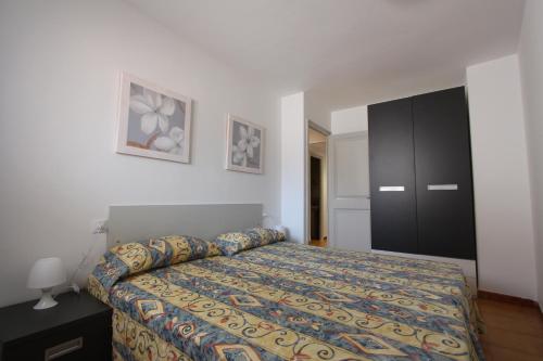 a bedroom with a bed and a black cabinet at Residencial Super Stop Palafrugell in Palafrugell