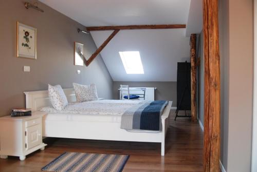 a bedroom with a white bed in a attic at Apartment House Timisoara in Timişoara
