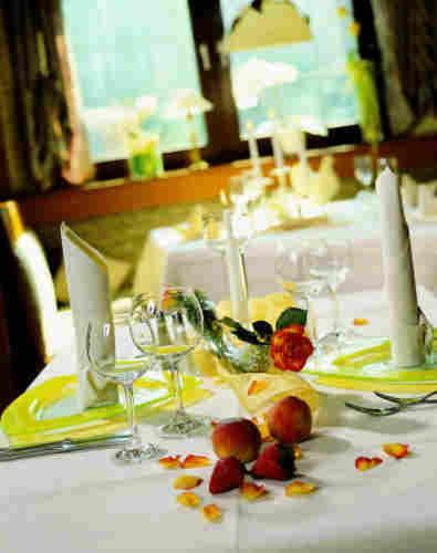 a table with wine glasses and fruit on it at Landgasthof zum Lamm in Bahlingen