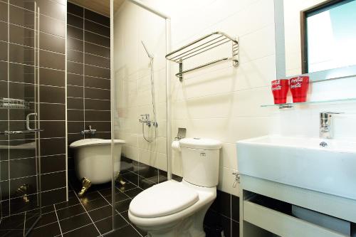 a bathroom with a toilet and a sink at Jack Castle in Tainan