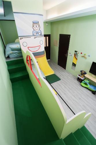 a bedroom with a bed with a painting on it at Jack Castle in Tainan