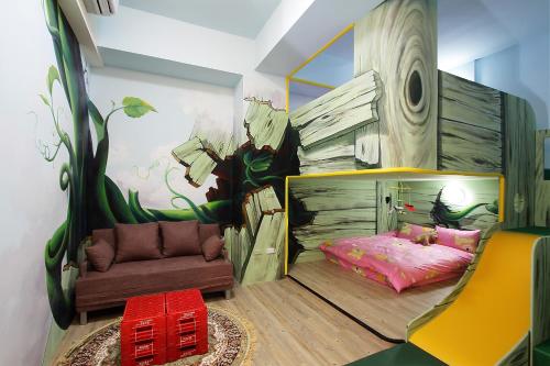 a childs bedroom with a mural of a tree at Jack Castle in Tainan
