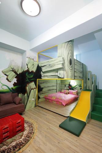 a bedroom with a bed with a painting on the wall at Jack Castle in Tainan