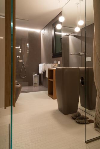 a bathroom with a toilet and a sink and a shower at Locanda Black and White Sondrio in Sondrio