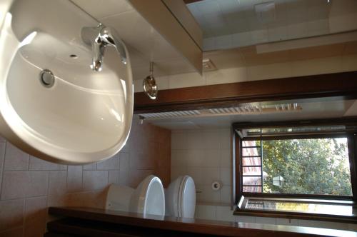 a bathroom with a sink and a window at Residenza Torre Acquatino in Spello