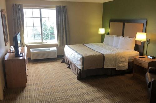 a hotel room with a bed and a window at Extended Stay America Suites - Cleveland - Airport - North Olmsted in North Olmsted
