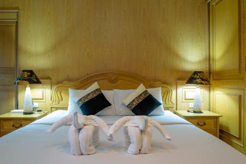 Postel nebo postele na pokoji v ubytování Hua Hin Condotel & Resort Taweeporn