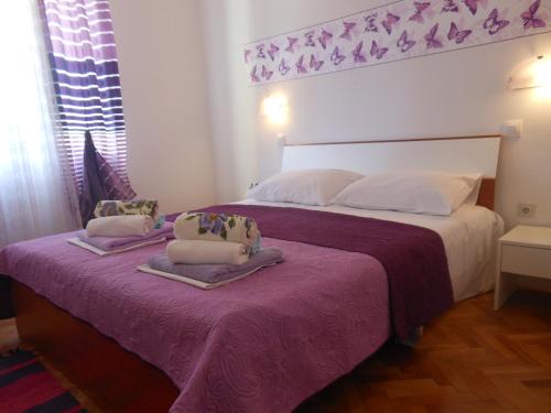 a bedroom with a bed with two pillows on it at Donami Apartments in Pag
