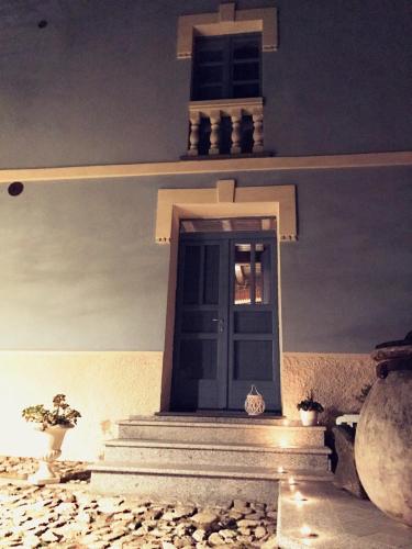 a church entrance with a blue door and stairs at Vesta in Sorgono