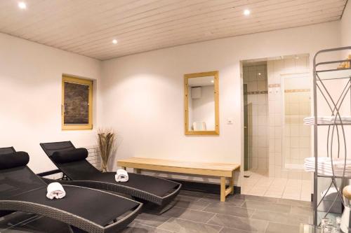 a bathroom with two chairs and a shower at Appartements Garni Alpin Live in Samnaun
