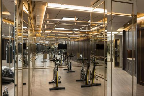 a gym with bikes and exercise equipment in a room at The Lanesborough, Oetker Collection in London
