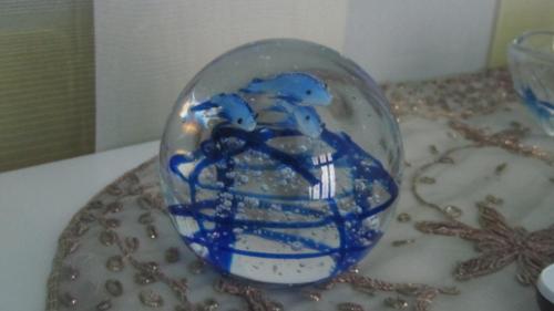 a glass ball with blue decorations on a table at Il Giovaiellino in Belpasso